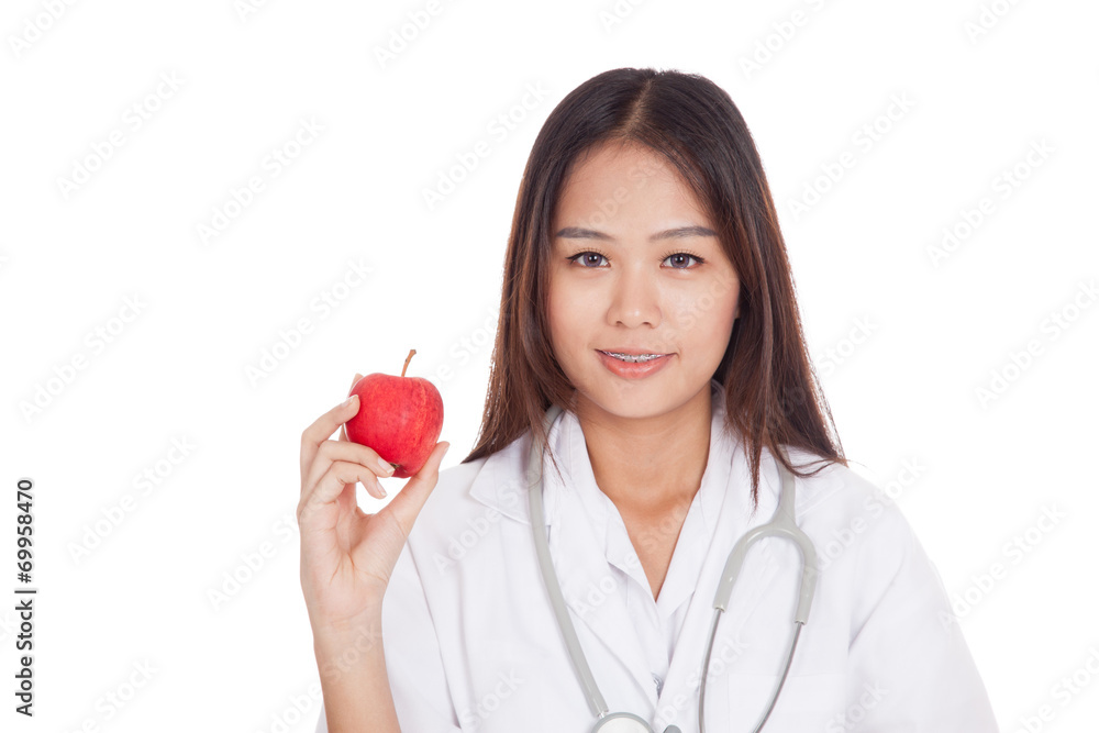 Young Asian female doctor smile show an apple Young Asian female doctor smile show an apple