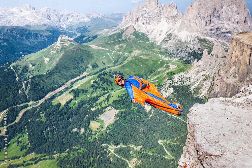 BASE jumper jumping off a big cliff in Dolomites,Italy, breathta