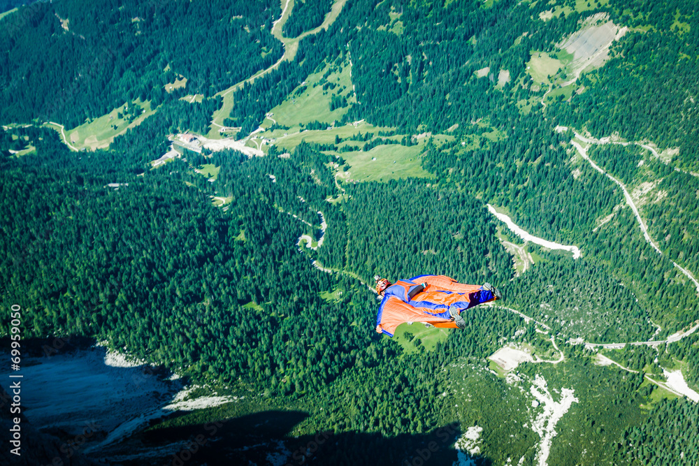 BASE jumper jumping off a big cliff in Dolomites,Italy, breathta