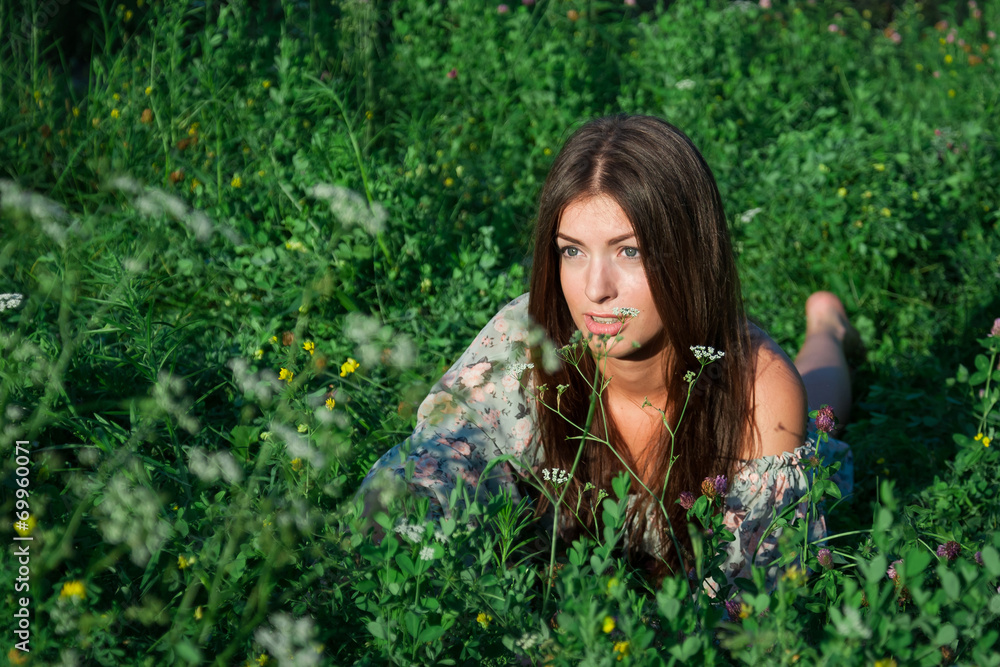 Nice girl among green grass and flowers Nice girl among green grass and flowers