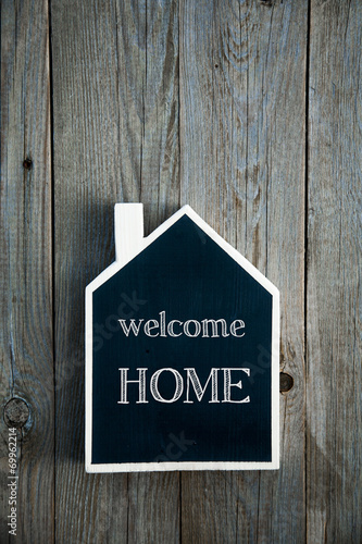 House Shaped Chalkboard sign on rustic wood WELCOME HOME