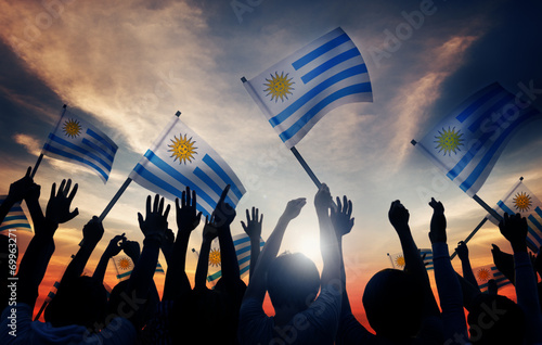 Fotografie Silhouettes of People Holding Flag of Uruguay