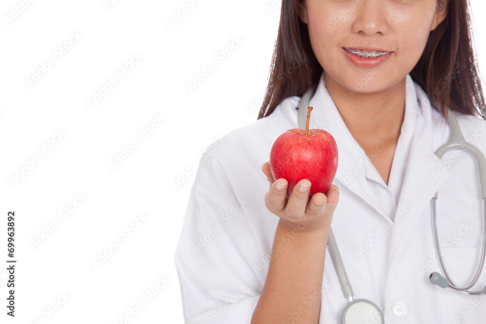 Close up young asian female doctor smile show apple Close up young asian female doctor smile show apple