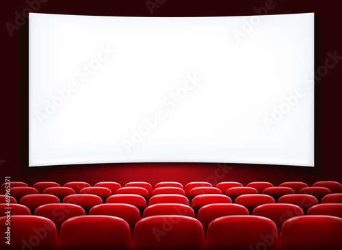 Rows of red cinema or theater seats in front of white blank scre