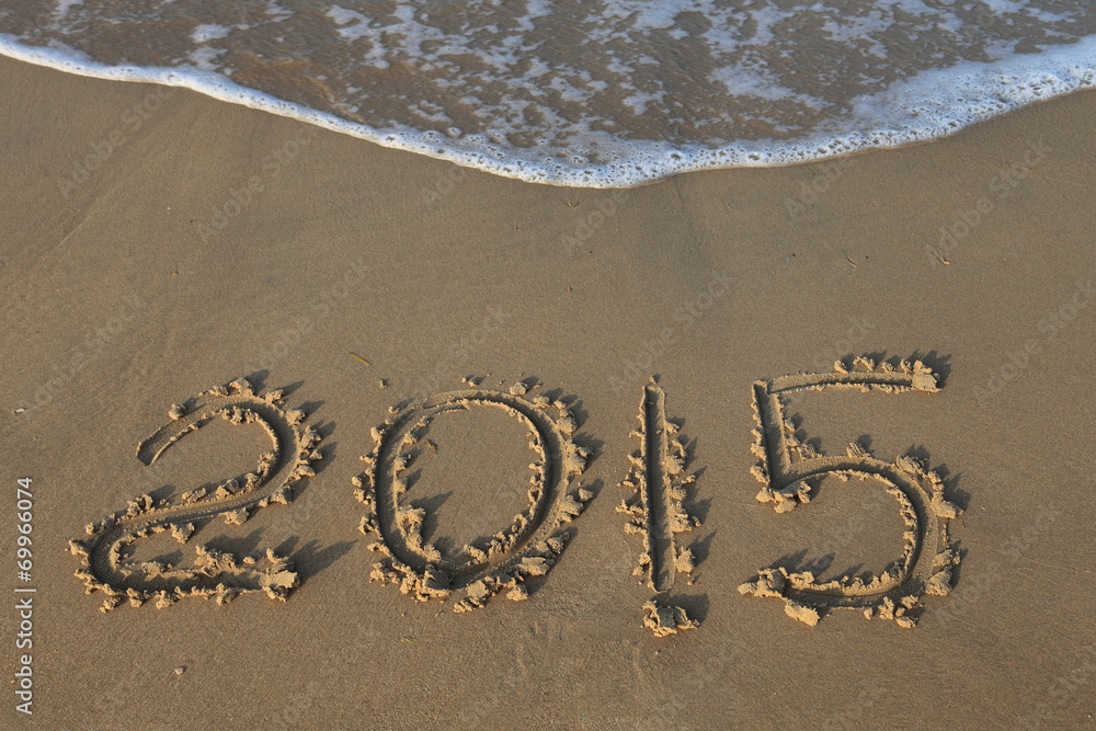 Fototapeta premium Year 2015 number written on sandy beach