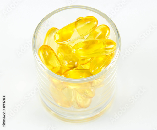 Healthy vitamin glass : yellow oil pills in translucent glass
