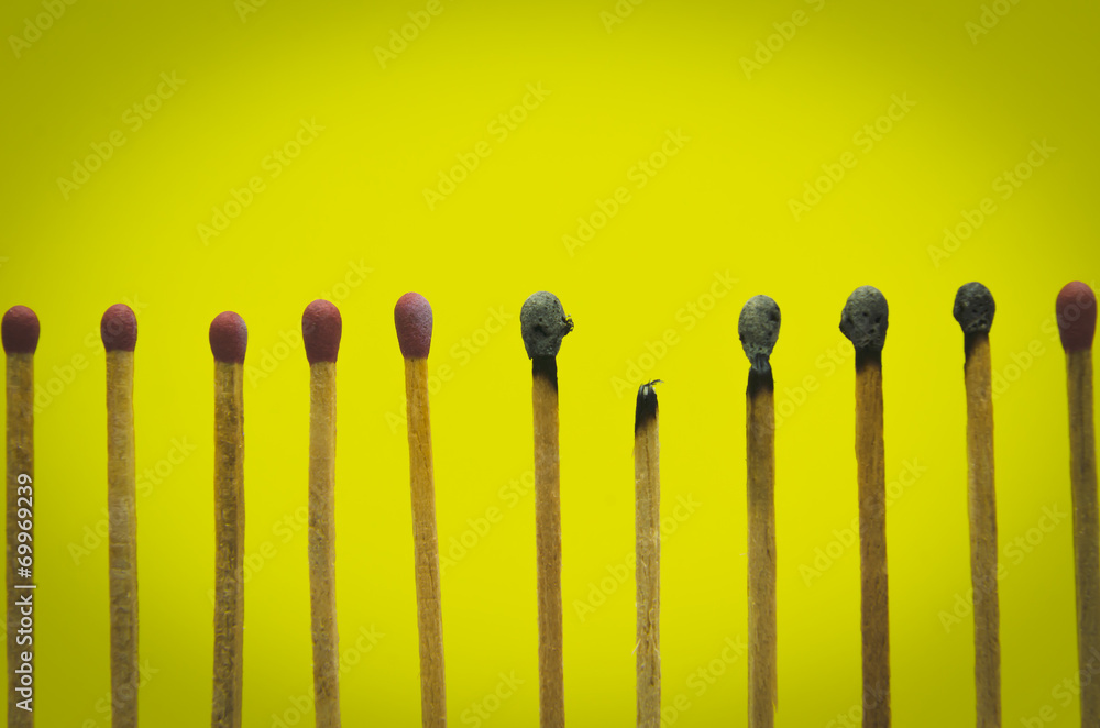 burned match setting on yellow background for ideas and inspirat burned match setting on yellow background for ideas and inspirat