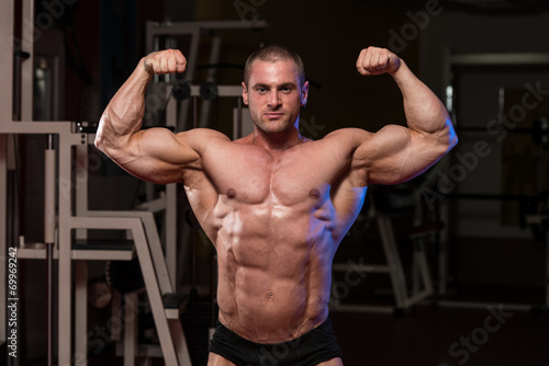 Muscular Man Is Hitting Rear Double Bicep Pose