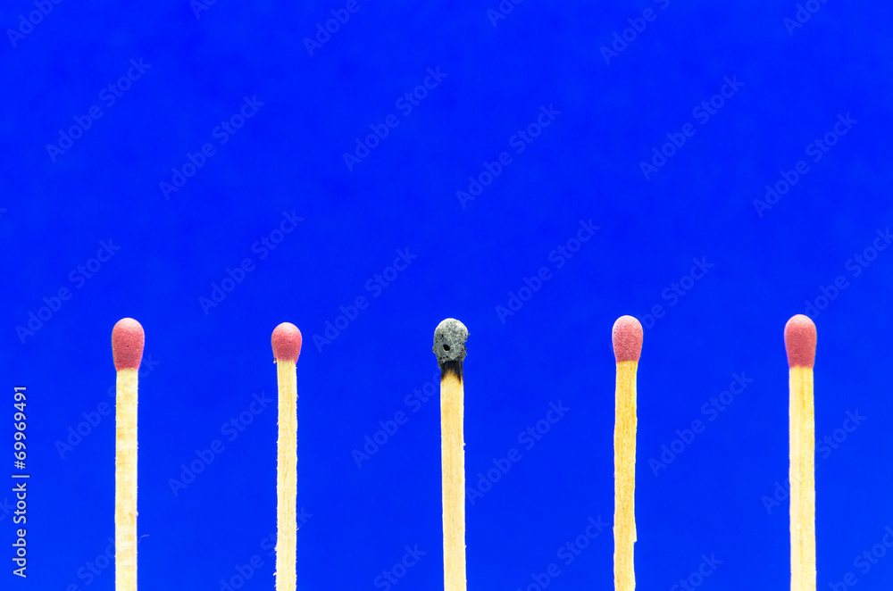 burned match setting on blue background for ideas and inspiratio burned match setting on blue background for ideas and inspiratio