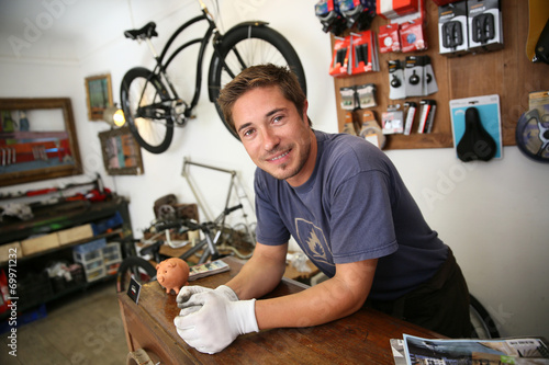 Portrait of smiling man working in bike rental shop