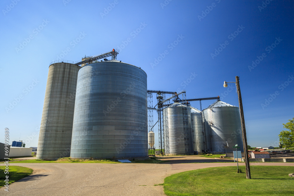 Silver, shiny agricultural silos Silver, shiny agricultural silos