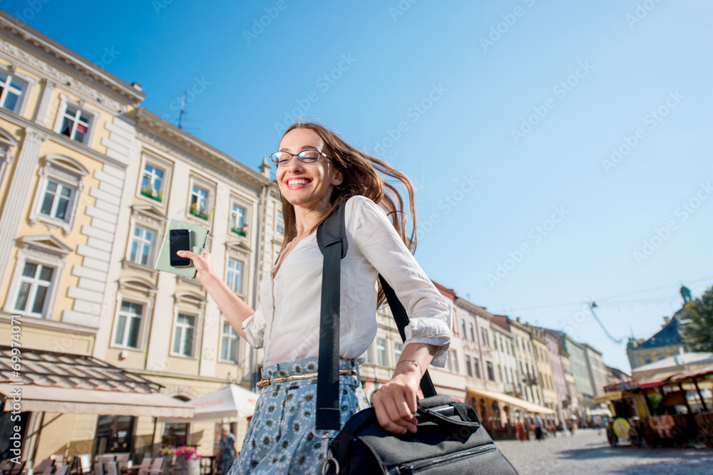 Young woman hurry to the work on the morning in the old city