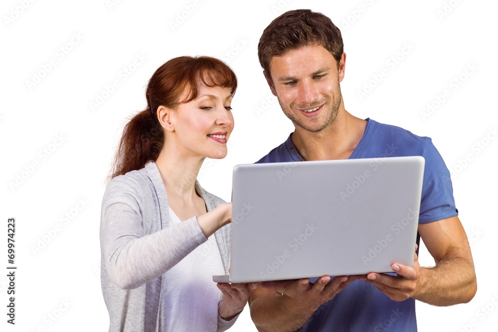 Couple using a laptop together Couple using a laptop together