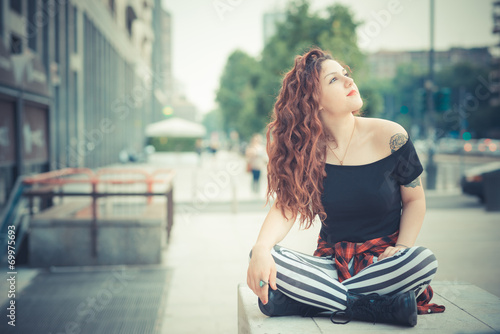 young beautiful hipster woman with red curly hair