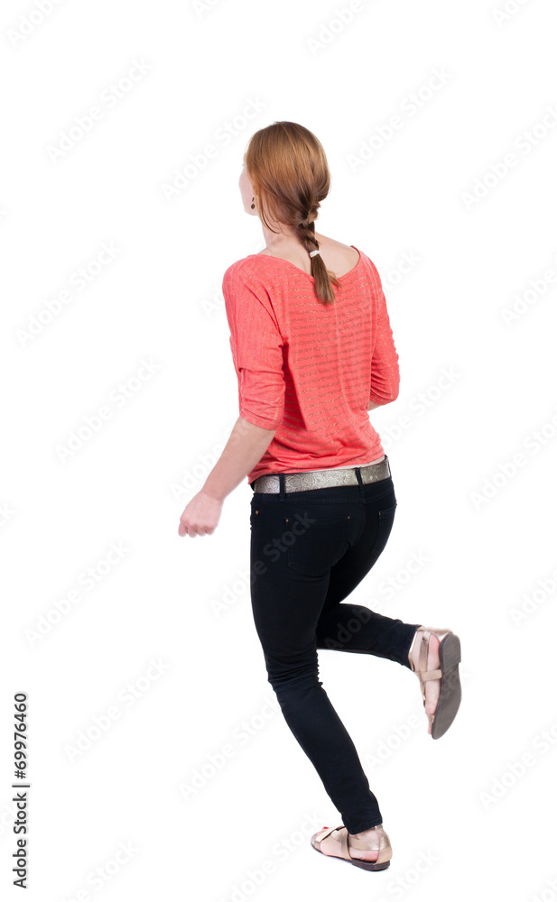 back view of running woman in jeans back view of running woman in jeans