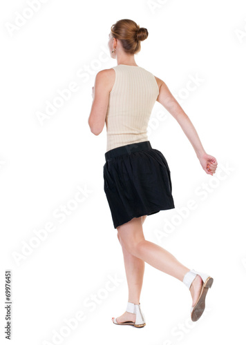 back view of running woman in dress