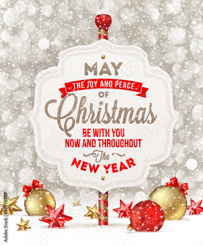 Signboard with greeting and Christmas decoration on a snow