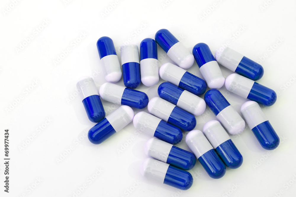 Close up of blue medical capsules isolated