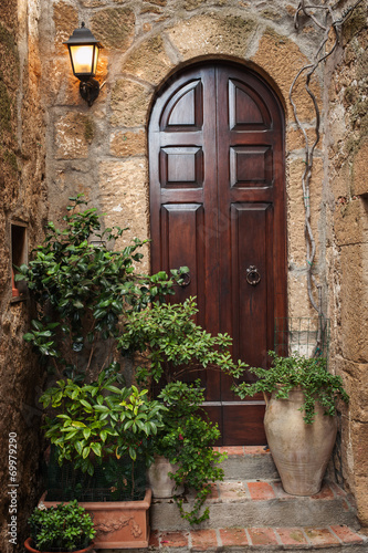 The door in the alley of the old Tuscan town, Italy