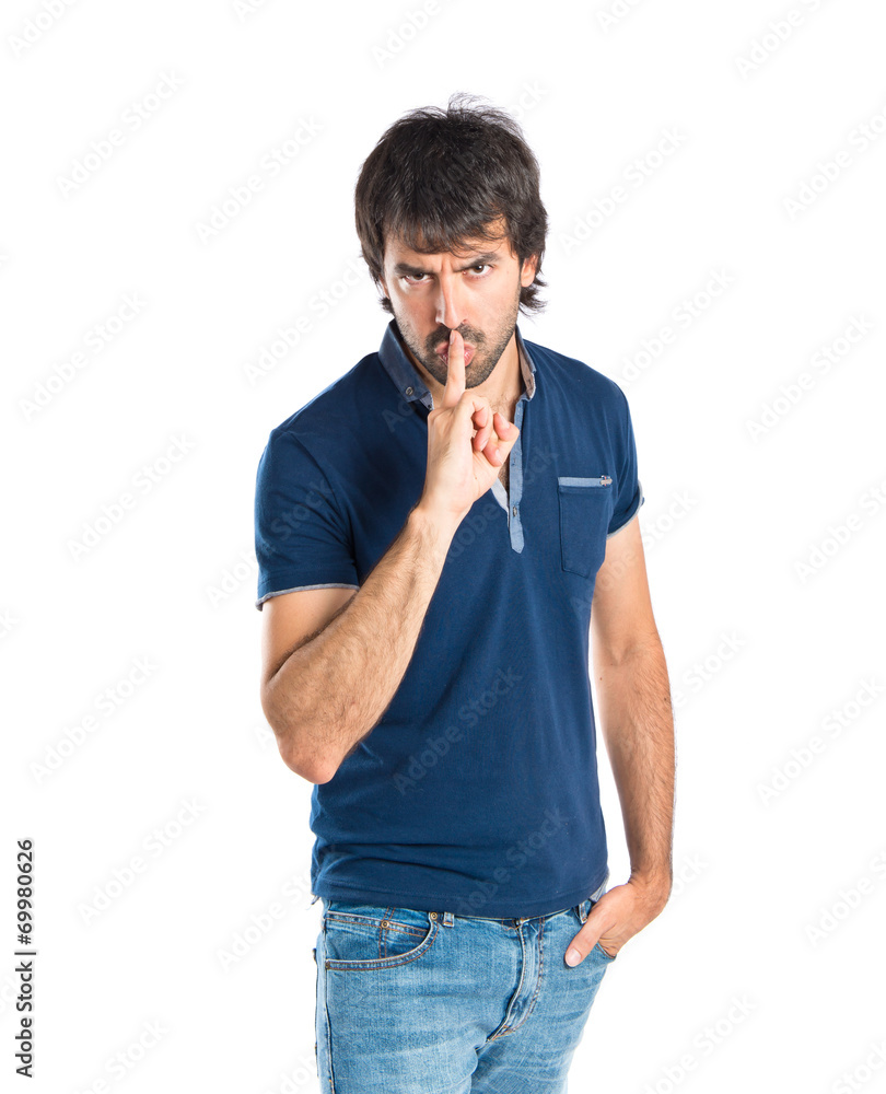 Man making silence gesture over isolated white background Man making silence gesture over isolated white background