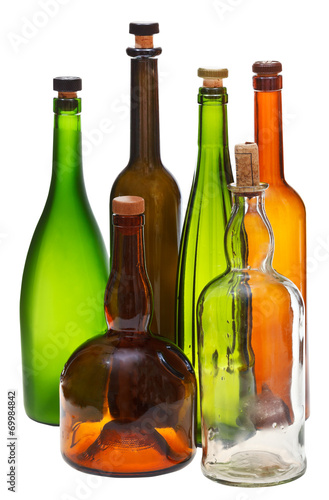 side view of several empty closed wine bottles