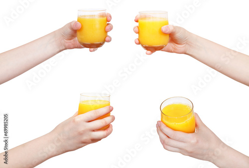 set of hand holds glass with orange juice