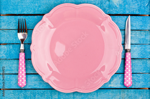empty plate and fork,knife on a blue wooden background