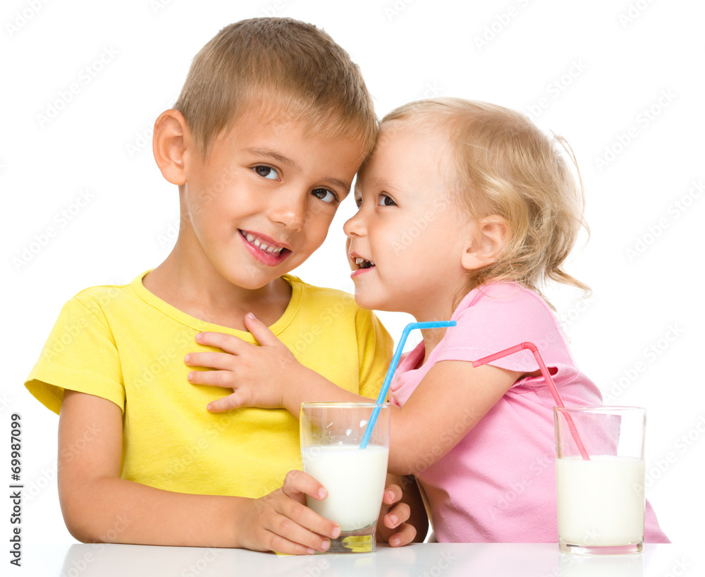 Cute little girl and boy are drinking milk Cute little girl and boy are drinking milk
