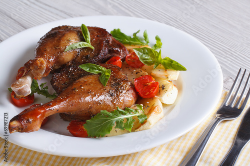duck legs roasted with apples, tomatoes and herbs horizontal