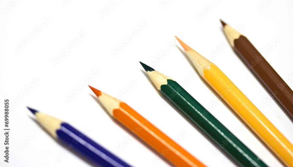 Colour pencils on white background close up Colour pencils on white background close up