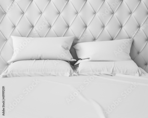 empty white bed and pillows with luxury headboard