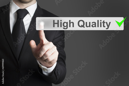 businessman pushing button high quality green check