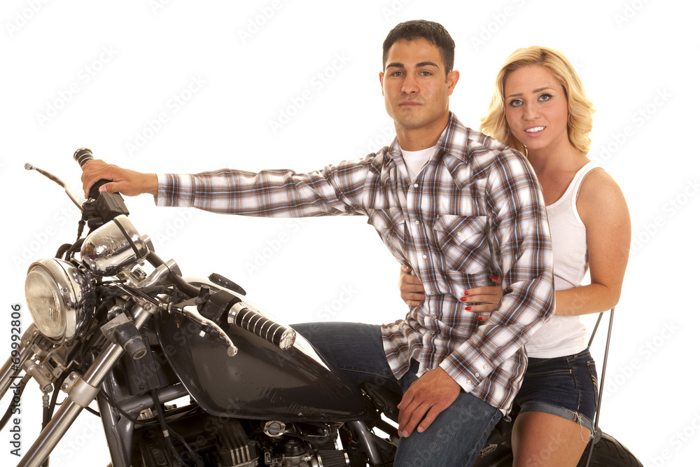 couple sitting on motorcycle close western serious