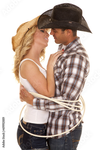 cowboy couple rope around them ready to kiss photo