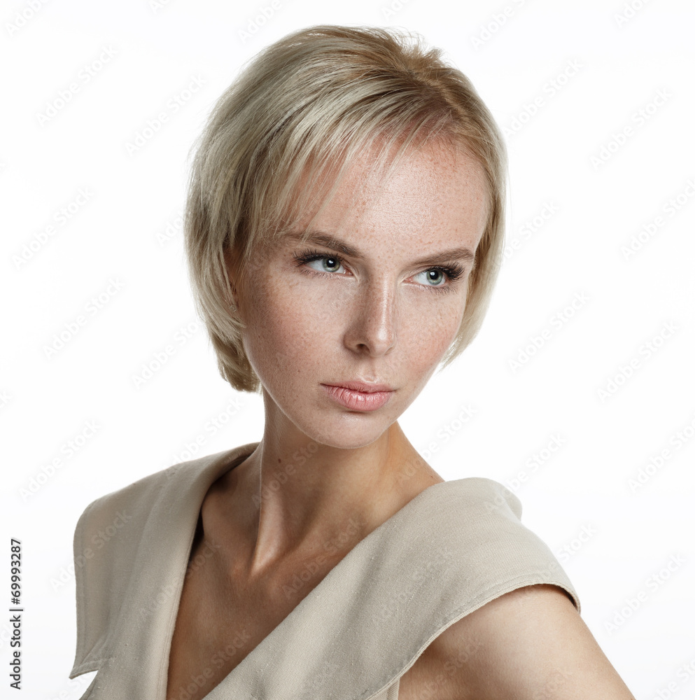 Beautiful blond model with freckles looking off camera Beautiful blond model with freckles looking off camera