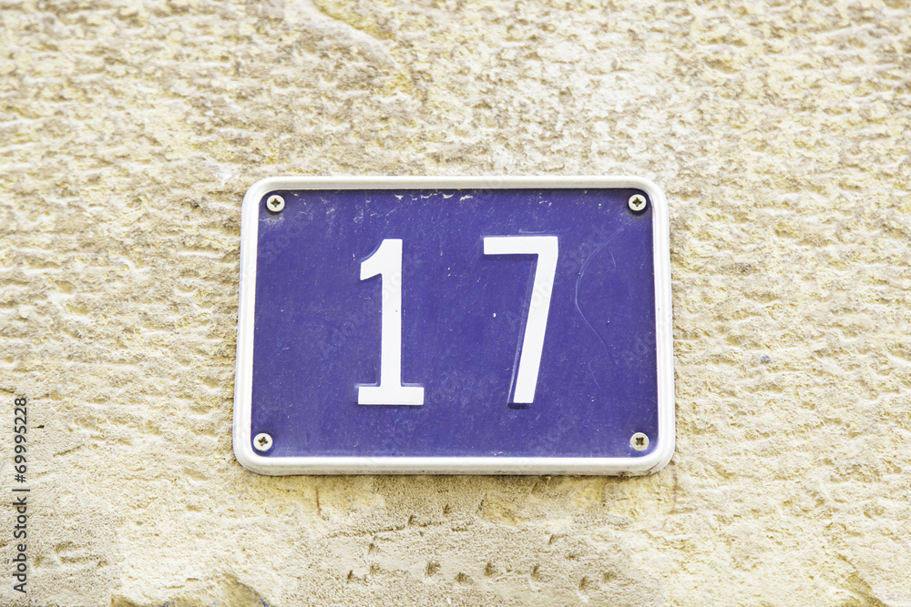 Number seventeen on the wall of a house Number seventeen on the wall of a house