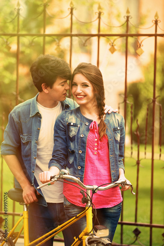 Young couple with bicycle o...