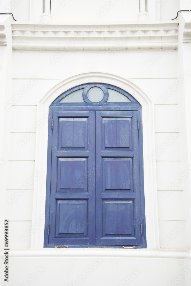 blue window on a white wall