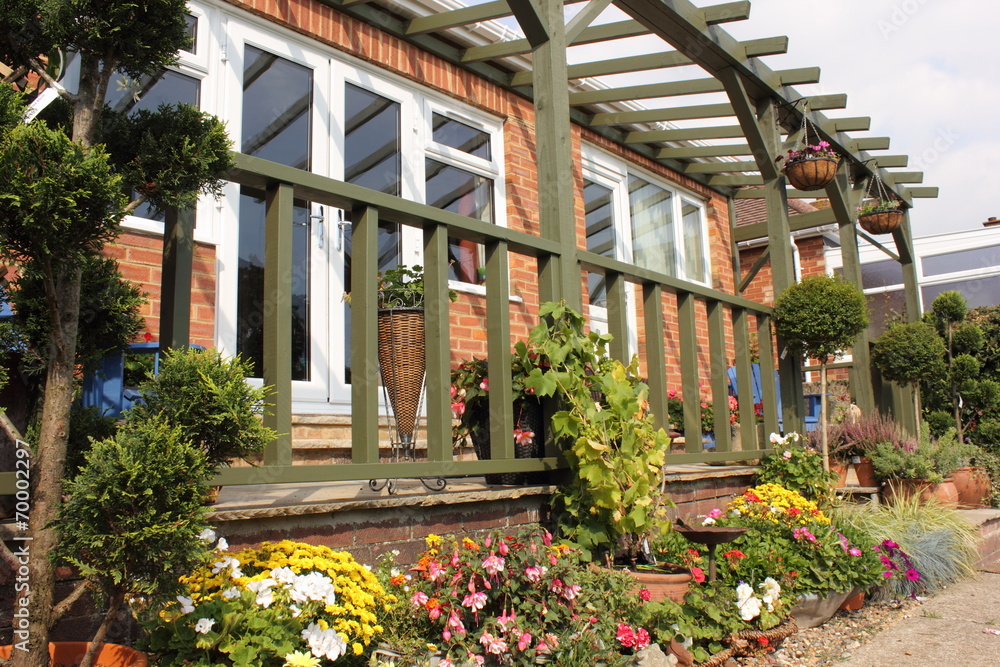 Fototapeta premium A colourful veranda on a bungalow with flowers and plants