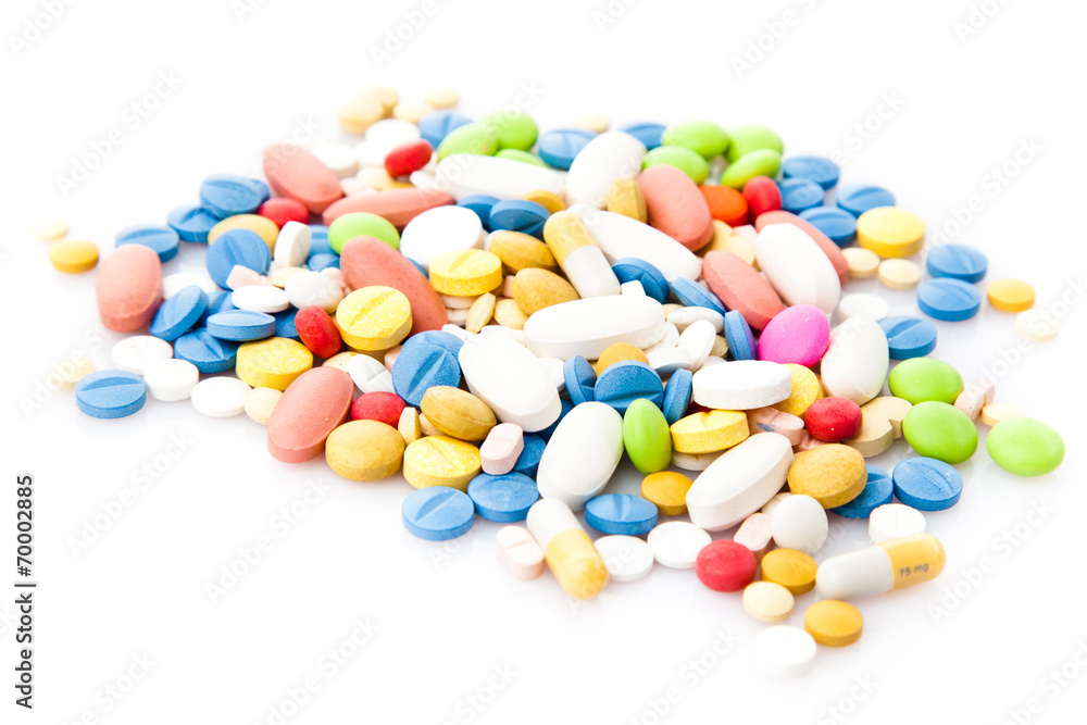 Pile of various colorful pills isolated on white Pile of various colorful pills isolated on white