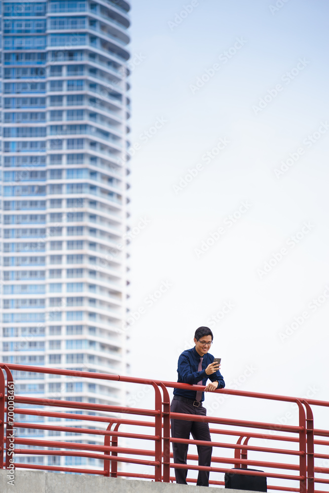 Portrait asian office worker texting mobile phone Portrait asian office worker texting mobile phone