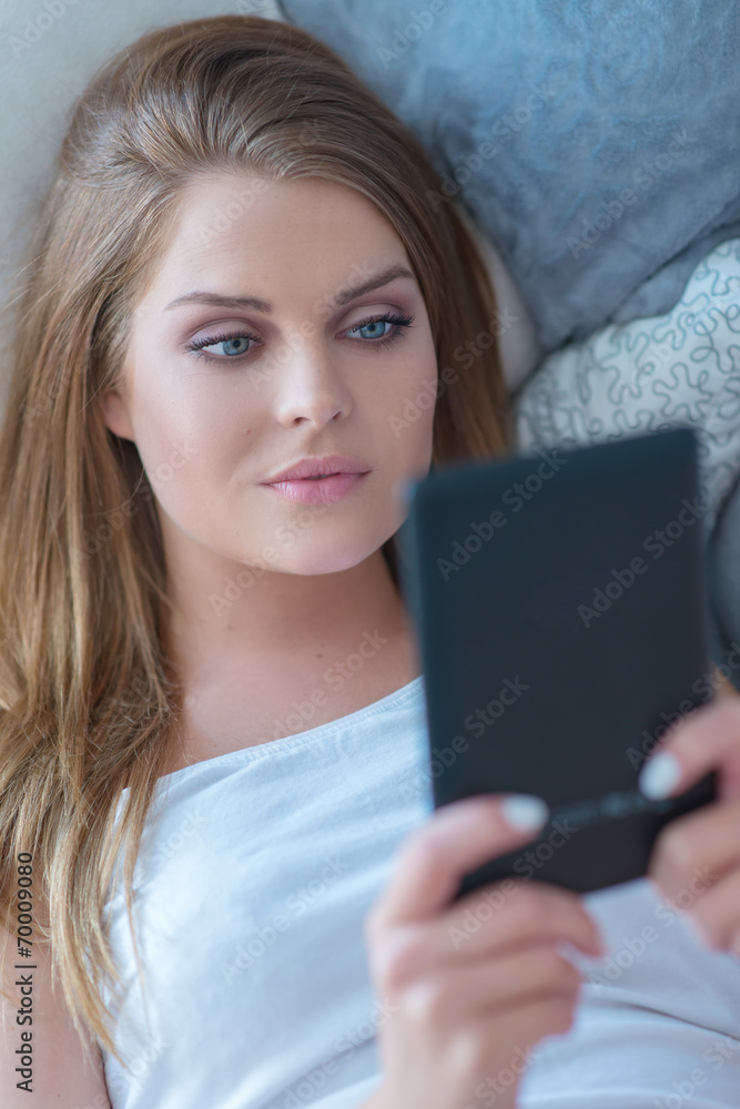 Beautiful woman reading on a tablet-pc Beautiful woman reading on a tablet-pc