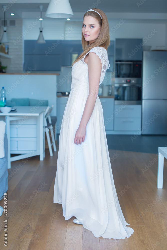 Woman Wearing Wedding Dress Standing in Kitchen Woman Wearing Wedding Dress Standing in Kitchen