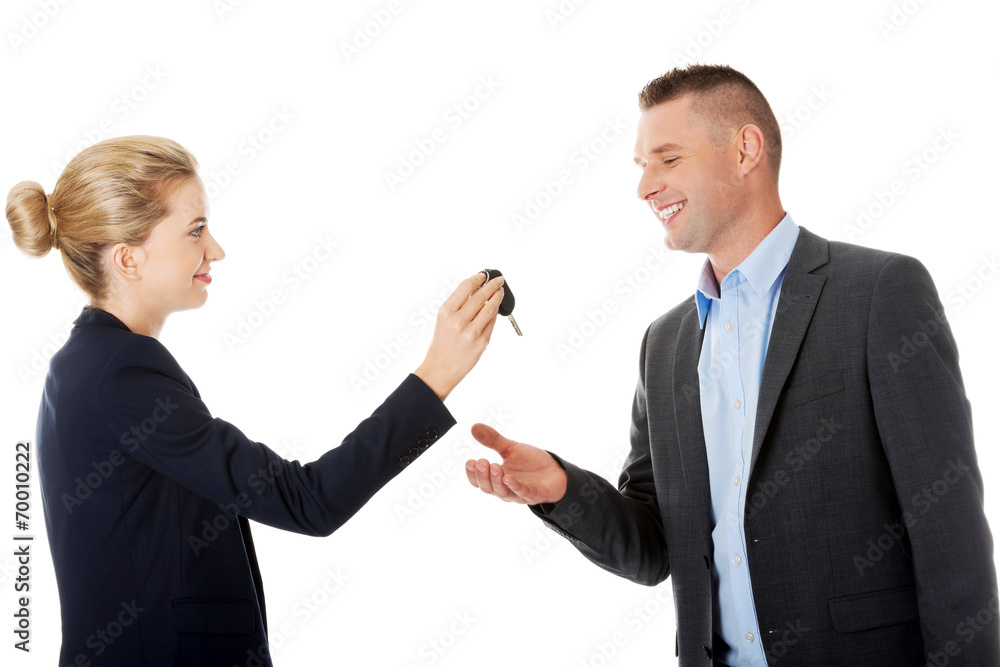 Car salesman handing over the keys Car salesman handing over the keys