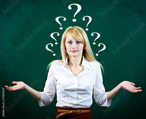 Photography Confused, puzzled young woman shrugs shoulders