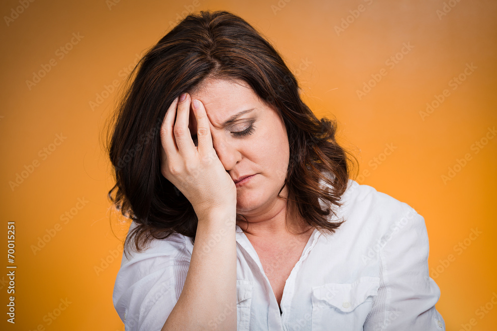 Headshot depressed, gloomy woman on orange background Headshot depressed, gloomy woman on orange background
