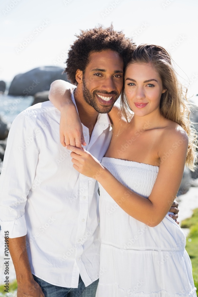 Gorgeous couple embracing by the coast Gorgeous couple embracing by the coast