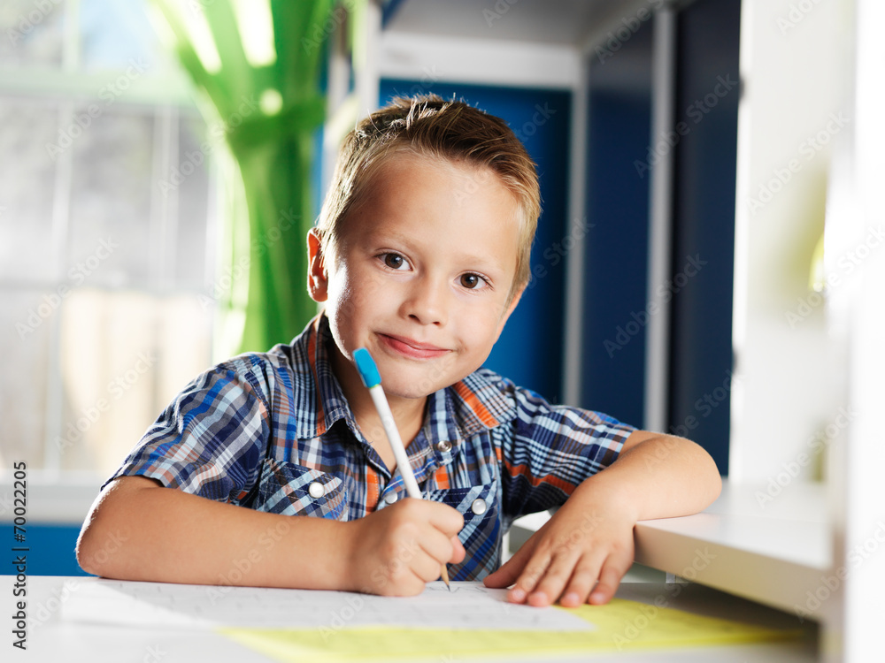enthusiastic little boy doing homework enthusiastic little boy doing homework