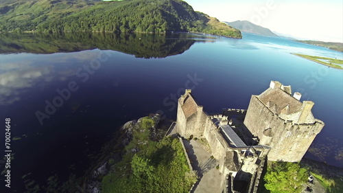 Two scenes of camera flying near serene beautiful Eilean Donan C