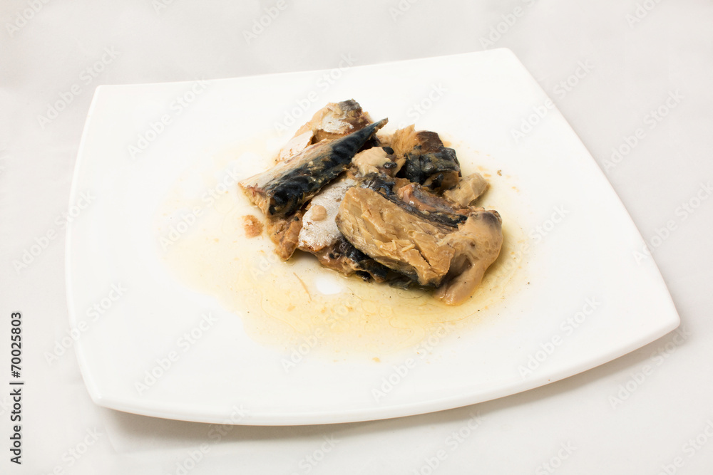 sprats on plate in oil on a white background sprats on plate in oil on a white background